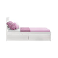 White single wooden bed with pink fitted sheet, textured pink throw and pillows, two under-bed storage drawers on white background
