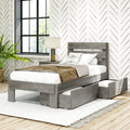 Modern farmhouse bedroom with gray wooden storage bed with under-bed drawers, white neutral bedding, chevron wallpaper and black grid window