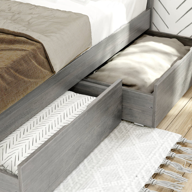 Gray wood platform bed with pull-out under-bed storage drawers, neutral linen bedding and patterned rug — space-saving bedroom storage