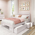 Modern pink and white bedroom with whitewashed platform storage bed and pull-out drawers, blush bedding, floral gallery wall, sheer curtains and natural light