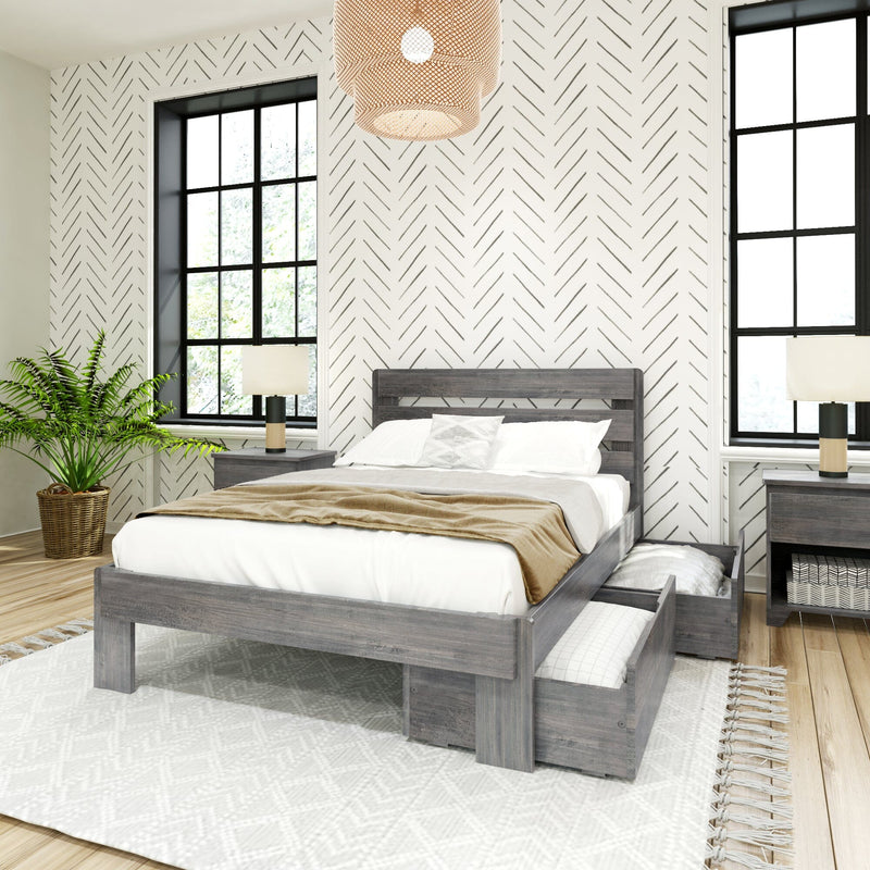 Modern farmhouse bedroom with gray wood platform bed and under-bed storage drawers, white geometric herringbone accent wall, black grid windows, woven pendant light, bedside lamps and potted fern.