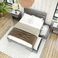 Modern farmhouse bedroom top view featuring a gray wooden storage bed with open under-bed drawers, neutral beige and white bedding, gray nightstand with lamp, woven boho pendant light, patterned accent wall, potted plant and hardwood floors