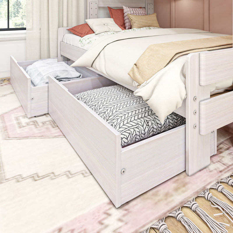 Whitewashed wood trundle bed with under-bed storage drawers, cozy cream and patterned bedding and blush decorative pillows in a bright modern bedroom