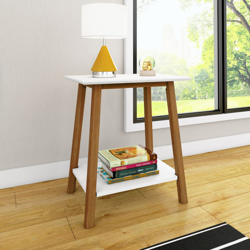 Mid-century modern wooden side table with white top and lower shelf holding books and a yellow cone table lamp beside a large window in a bright living room