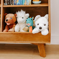 Kids wooden bookshelf with plush stuffed animals (bear, llama, green dragon, white husky) and children's books