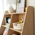 Scandinavian light-wood kids bookshelf with ceramic table lamp, framed palm print, woven storage basket and Crayola crayons
