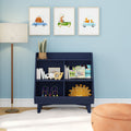 Nursery wall art: three framed whimsical animal car prints above a navy bookshelf with children's books, wooden toys and lamp — kids room decor, blue nursery