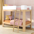 Modern natural wood bunk bed loft for kids with pink bedding, ladder, yellow pillows and pastel patterned nursery wallpaper