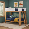 Wooden loft bunk bed in kids' room with navy bedding, striped pillows, mustard throw, green textured wallpaper and trophy & sneaker wall art
