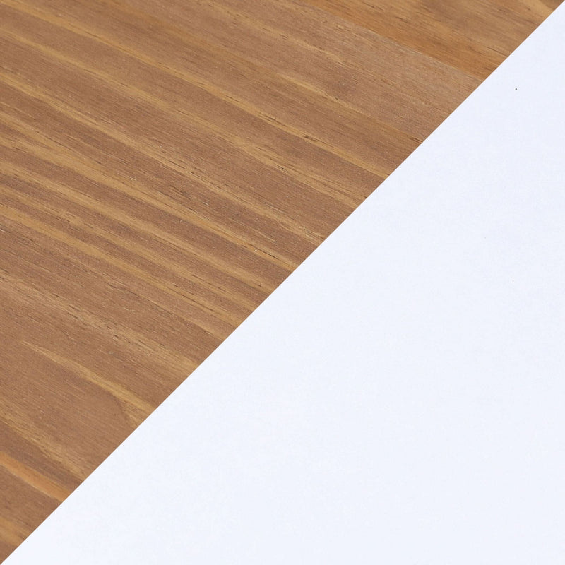 Close-up warm wood grain tabletop with diagonal white paper corner — minimalist desk background for workspace flatlay