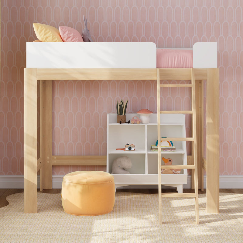Kids loft bed with wooden ladder, pink arch-pattern wallpaper, pastel pillows and bedding, storage cubbies with toys