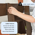 Hand gripping brown wooden bunk ladder with 200 lb weight capacity badge and feature callouts for grooved no‑slip steps, angled climb and secure hook attachment — loft and bed ladder safety