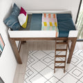 Top view of a modern wooden loft bed with white guardrail and ladder, teal sheets, colorful throw blanket and decorative pillows over a patterned rug