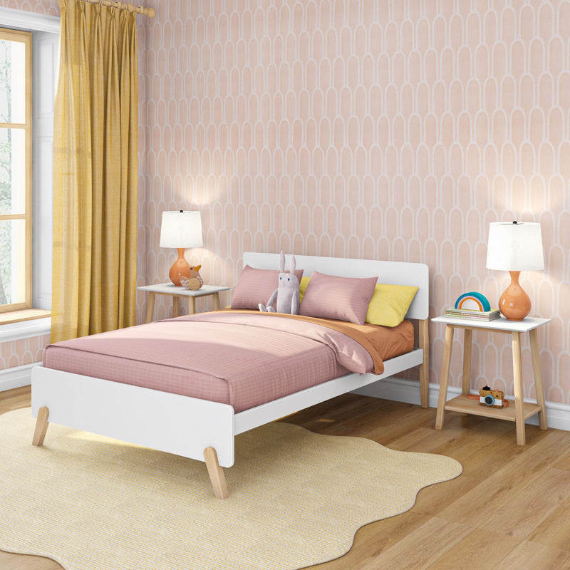 Modern kids bedroom with pink bedding, white wooden bed, yellow curtains, peach geometric wallpaper, bedside lamps and plush bunny toy