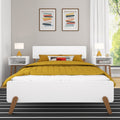 Modern Scandinavian bedroom with mustard yellow quilted bedding on a white mid-century platform bed, matching nightstands with yellow lamps and abstract framed wall art
