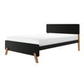 Modern black platform bed frame with wooden tapered legs and a white mattress on a minimalist white background