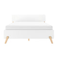 Modern minimalist white platform bed with upholstered headboard and light wooden tapered legs, Scandinavian-style bedroom furniture