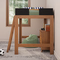 Wooden kids loft bed with ladder, green bean bag, striped pillows, bedside dresser and soccer ball under a forest-view window