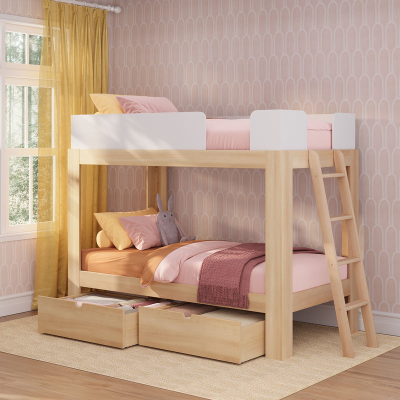 Kids bunk bed with under-bed storage drawers, light wood frame and ladder, pink bedding and pillows in a modern children's bedroom with yellow curtains and patterned wallpaper