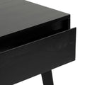 Close-up of black wooden nightstand with open drawer and angled leg, modern minimalist bedside table detail