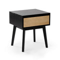 Modern black wooden nightstand with light oak drawer and angled tapered legs, minimalist mid-century bedside table