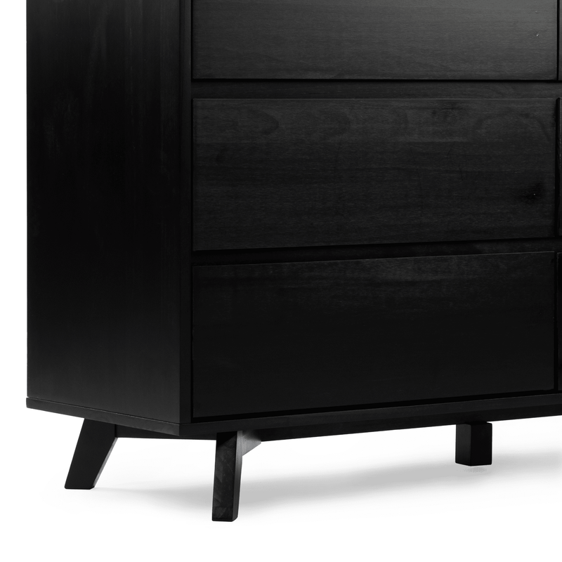 Close-up of a black wooden mid-century modern dresser — three-drawer chest with matte finish and tapered angled legs on a white background, modern bedroom storage furniture