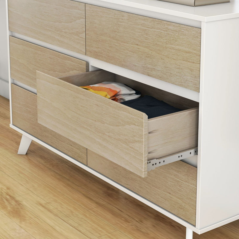Mid-century modern light wood dresser with open drawer showing folded clothes, bedroom storage on hardwood floor