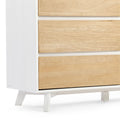 Mid-century modern three-drawer dresser with white frame, light natural wood drawer fronts and angled tapered legs for minimalist bedroom storage