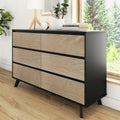 Mid-century modern 6-drawer dresser with black metal frame and light oak fronts in bright bedroom, styled with lamp, clock, books and potted plant.