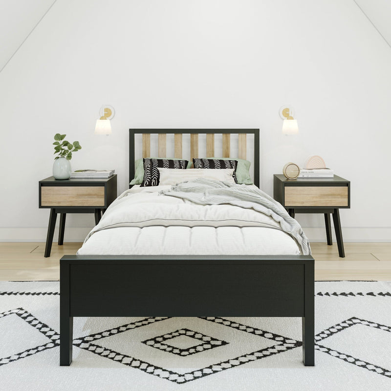 Minimalist modern bedroom with black wood bed frame, light wood headboard, matching nightstands, wall sconces, patterned rug and neutral bedding