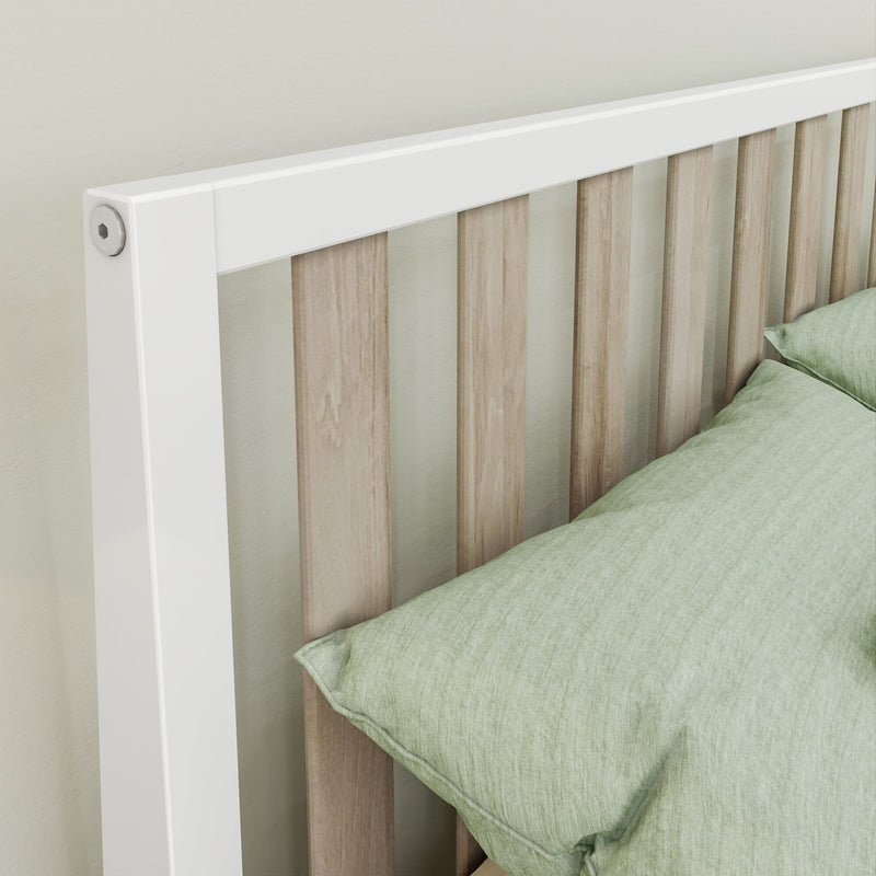Close-up of modern white-framed bed headboard with light oak slatted panels and sage green bedding in minimalist bedroom interior