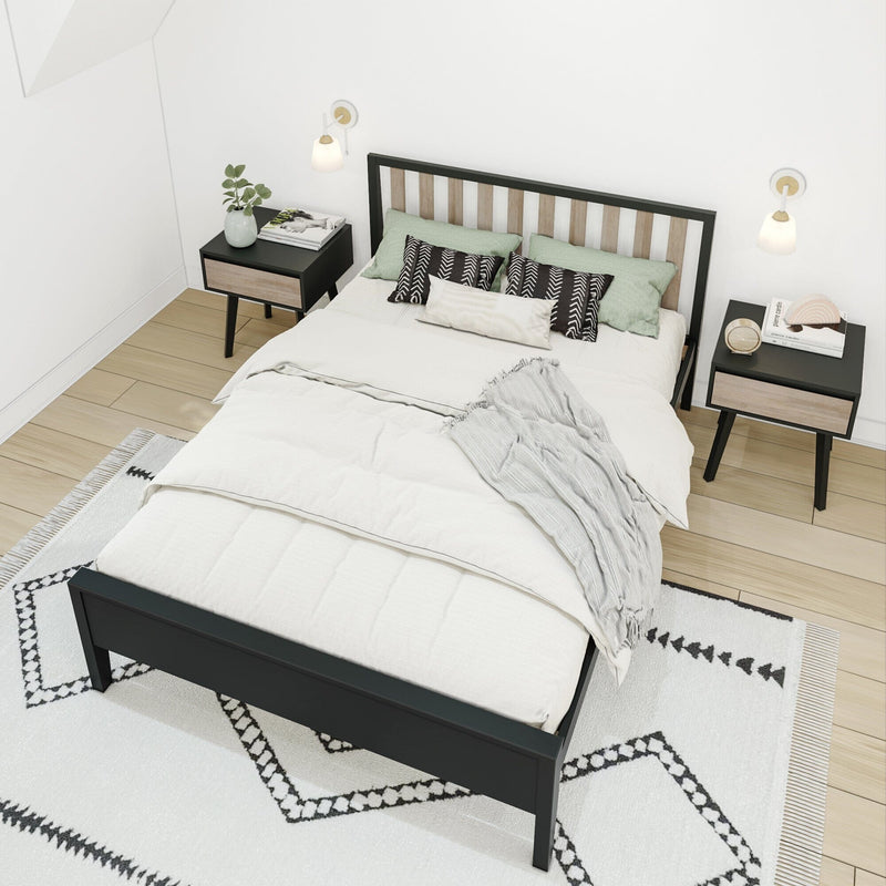 Minimalist Scandinavian bedroom with black wood bed frame and light wood slat headboard, neutral bedding, patterned rug, matching nightstands and wall sconces