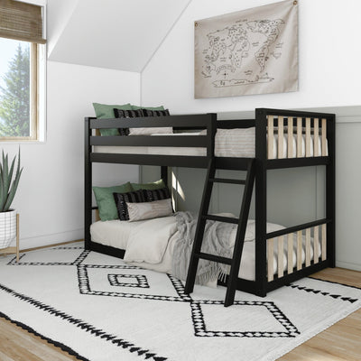 Modern kids' bedroom with black wooden bunk bed and ladder, white geometric rug, green throw pillows and vintage map wall art by a sunny window