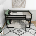 Black wooden bunk bed with ladder in a minimalist kids bedroom, neutral bedding, green throw pillows, world map wall art and black-and-white geometric rug