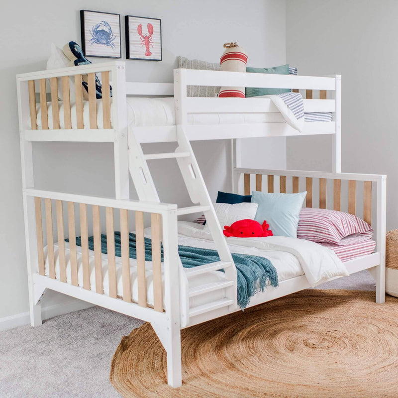 White wooden twin-over-twin bunk bed with ladder, striped bedding, nautical wall art and red crab plush in bright coastal kids' bedroom