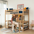 Young girl standing by natural wood loft bed with ladder, built-in desk and storage in modern kids' bedroom, navy bedding and "Go change the world, kid" wall banner