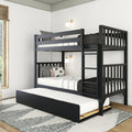 Black wooden bunk bed with pull-out trundle, ladder and white striped bedding in a modern kids' bedroom with wall sconces and natural light.
