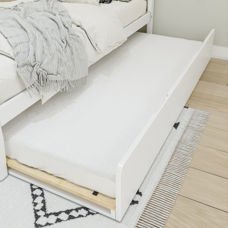 White wooden trundle bed with pull-out mattress, cream bedding and textured gray throw on light wood floor and patterned rug