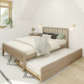 Minimalist Scandinavian bedroom with wooden platform bed and pull-out trundle, neutral linens, patterned rug, bedside table with vase, wall sconces and sunlit window with blinds