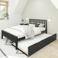 Scandinavian-style minimalist bedroom with black wooden bed frame and trundle, white bedding, patterned pillows, wall sconces, window blinds and potted plant