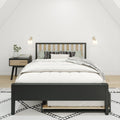 Modern minimalist bedroom with black-frame wood-slat bed, white bedding and patterned pillows, nightstand with books and vase, wall sconces and neutral decor