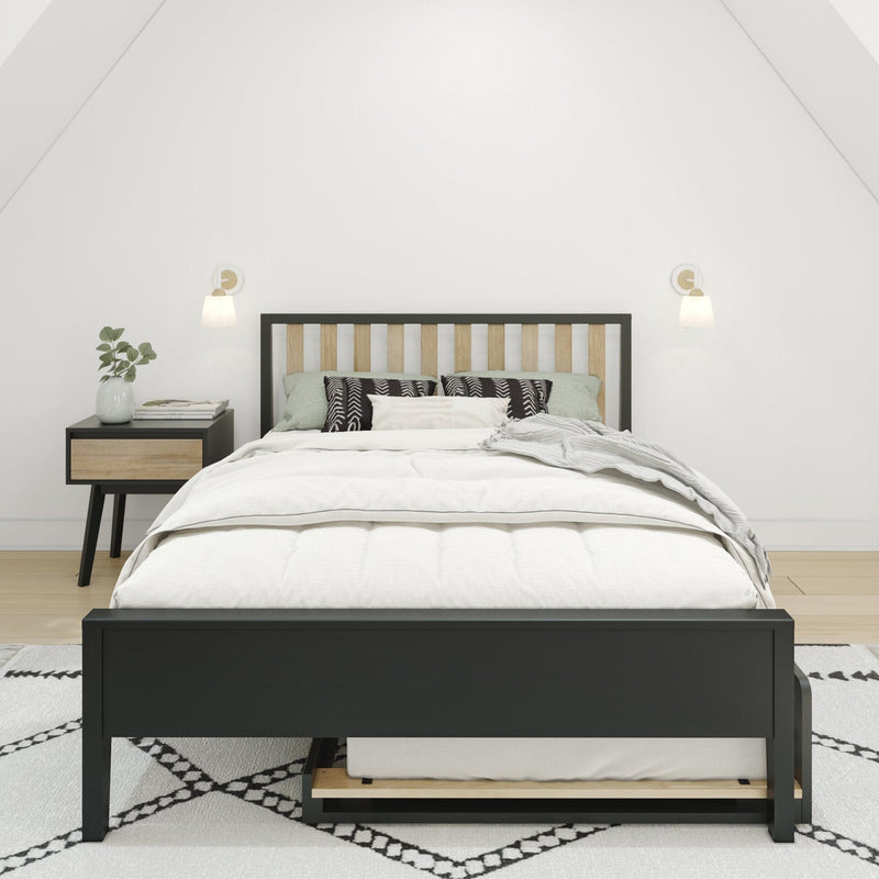Modern minimalist bedroom with black-frame wood-slat bed, white bedding and patterned pillows, nightstand with books and vase, wall sconces and neutral decor