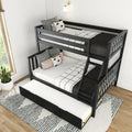 Modern black wooden triple bunk bed with pull-out trundle and ladder, monochrome grid bedding and decorative pillows in a bright kids' bedroom