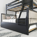 Modern black-framed loft bunk bed with ladder, slatted guardrails and lower trundle, styled with neutral pillows and a wall lamp in a minimalist bedroom