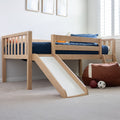 Natural wood kids loft bed with slide and navy bedding in a bright children's bedroom with sports beanbag and toy balls