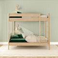Minimal Scandinavian natural wood bunk bed with ladder, sage green vertical shiplap wall, green velvet pillows, neutral bedding and cone wall sconces in a modern kids' bedroom
