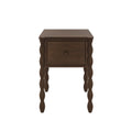 Brown wooden nightstand with one drawer, turned bobbin-style legs and visible wood grain finish on white background
