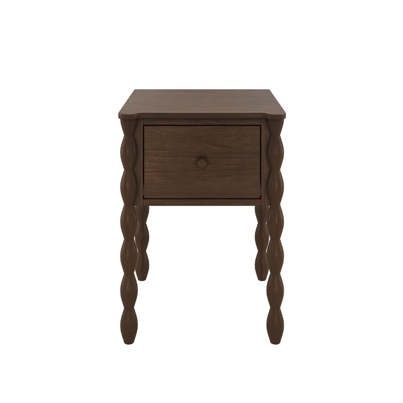 Brown wooden nightstand with one drawer, turned bobbin-style legs and visible wood grain finish on white background
