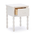 White nightstand bedside table with turned spindle legs and single open drawer showing natural wood interior and round knob — compact modern farmhouse storage table for bedroom or nursery