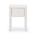 White wooden nightstand with single drawer and turned spindle legs, modern farmhouse bedside table on white background